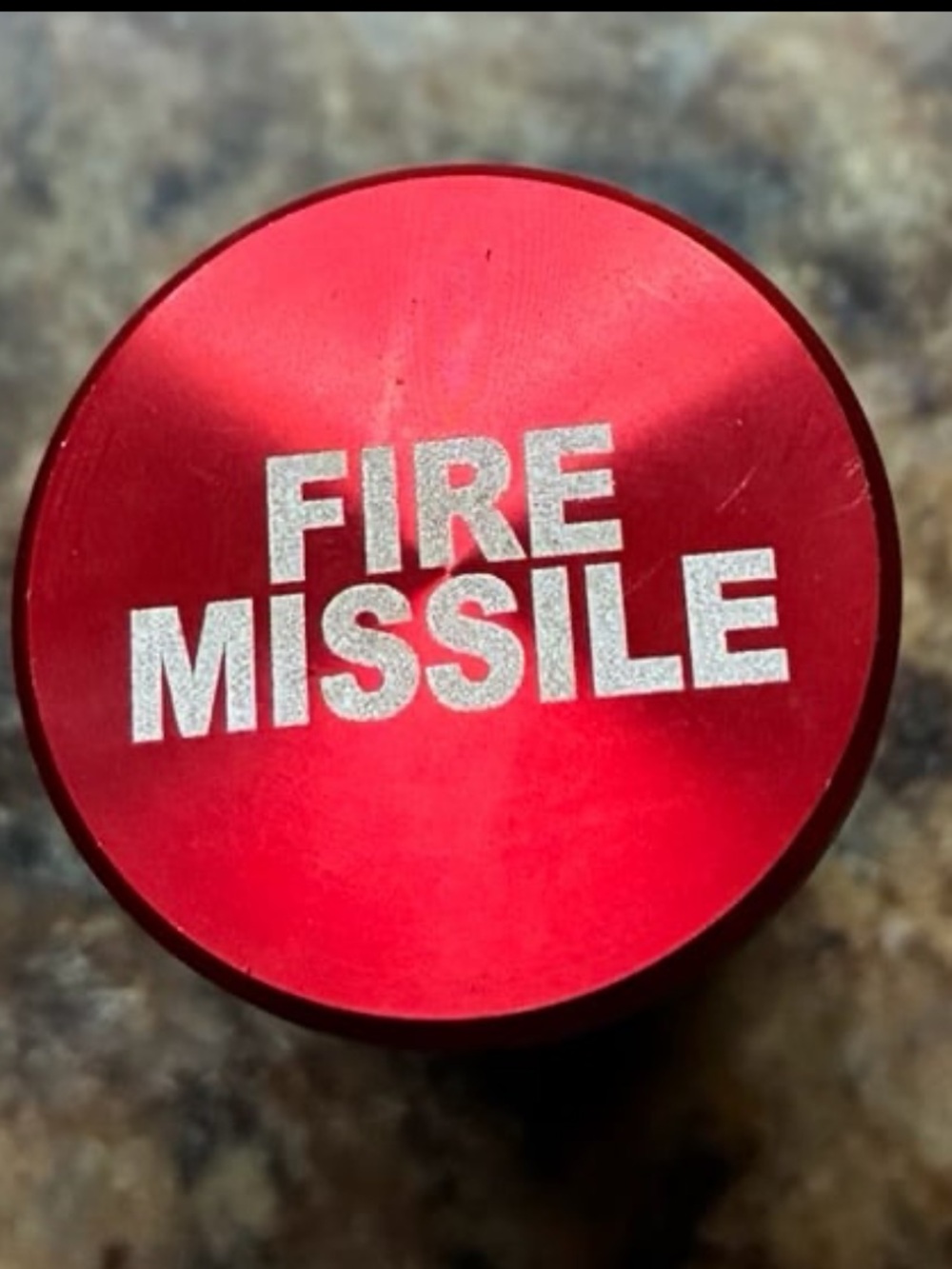 Red, Metallic Fire Missile Button is a Universal Cigarette Lighter Cover.